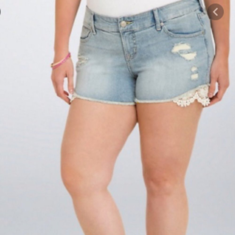 Light wash jean shorts with lace accent on side